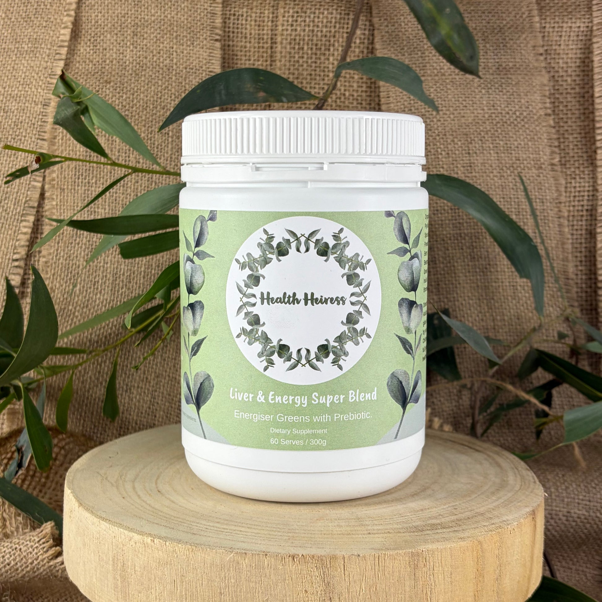 Supplement jar labeled 'Health Heiress' on a wooden block with plants in the background