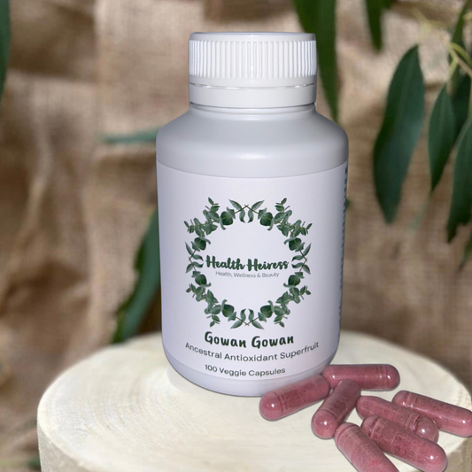 Supplement bottle labeled 'Health Heiress Gowan Gowan' with pink capsules on a natural background